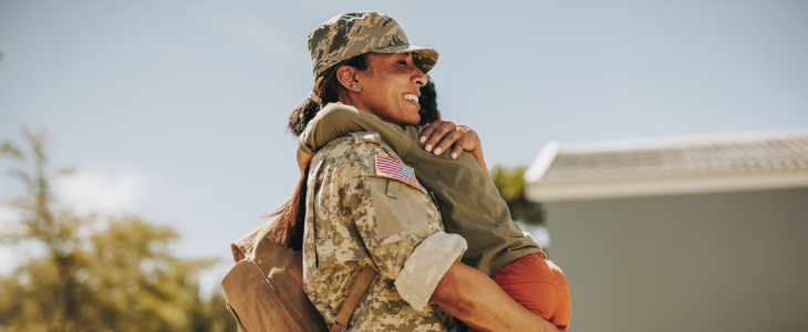 Joyful military mom embracing her son after returning home from the army