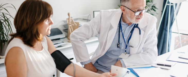 Doctor assisting older patient