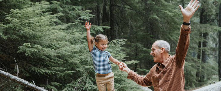elderly man playing with his granddaughter