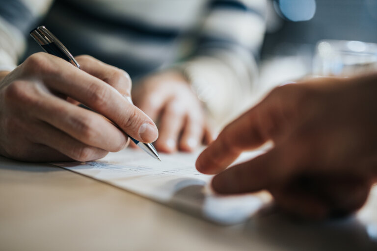 Man signing a trust document