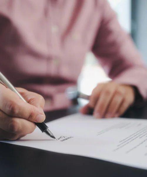 businesswoman signing an official document